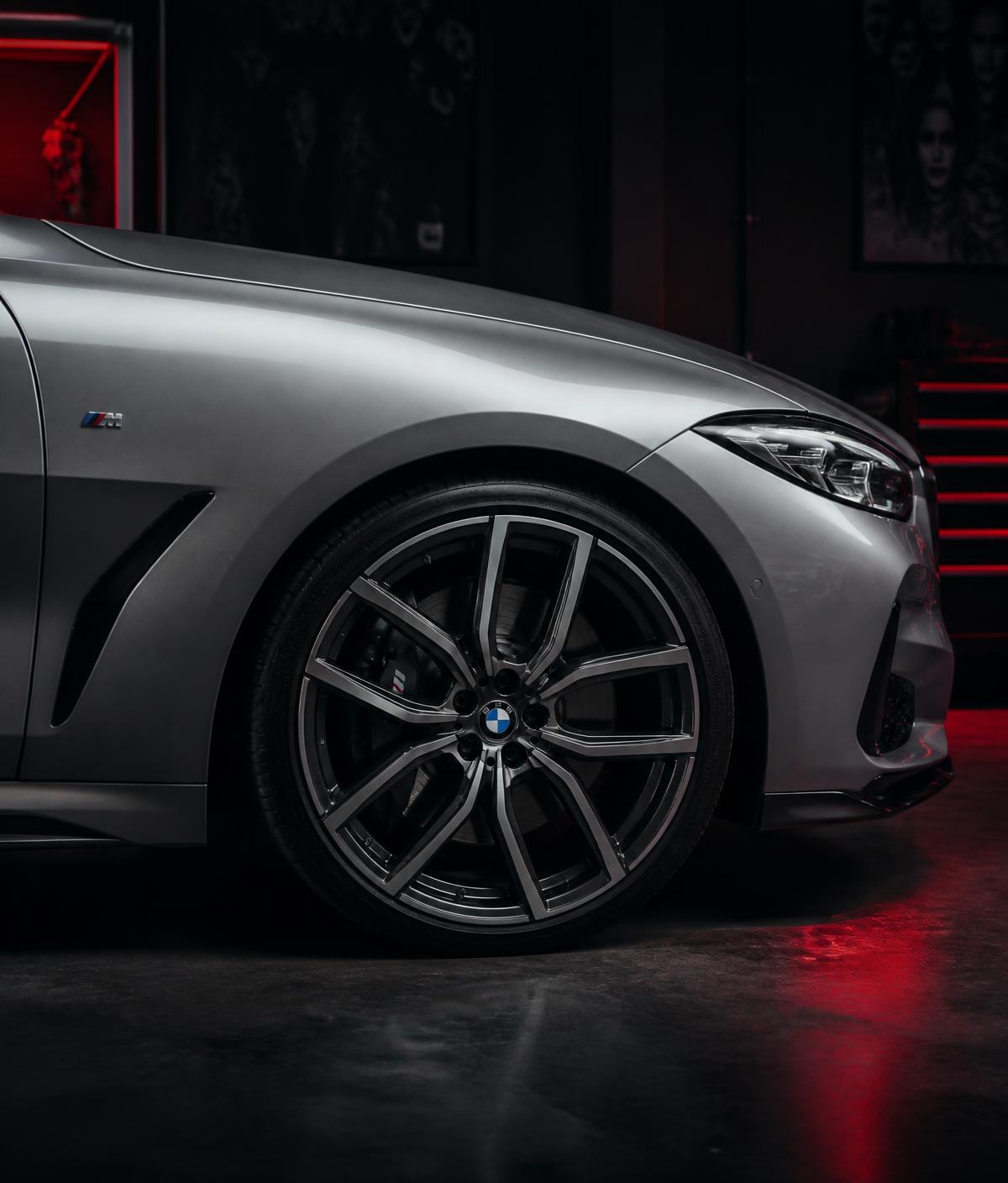 Front quarter panel and wheel of a premium German sedan in the Auto Haus workshop