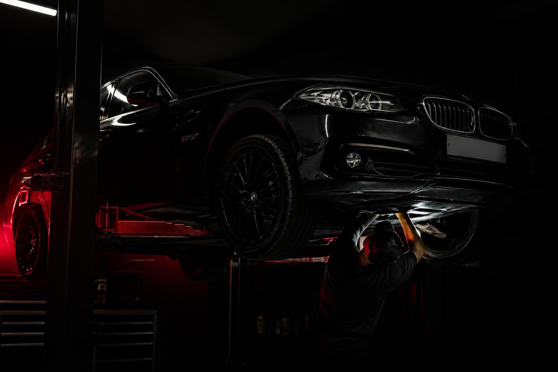 Technician servicing a German sedan on a lift at the Auto Haus Chicago shop
